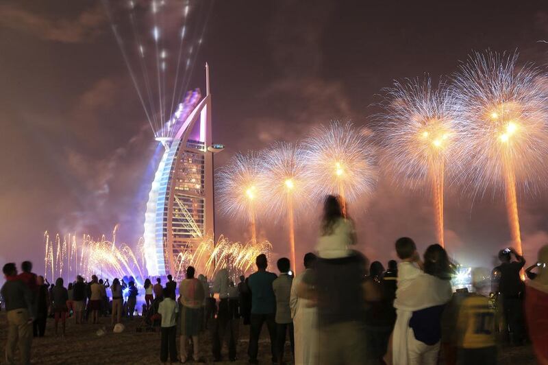 Fireworks celebrating the UAE's 42nd National Day explode over the Burj Al Arab near Umm Suqiem Beach in Dubai. Sarah Dea/The National





