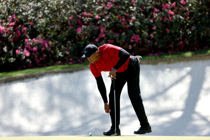 Tiger Woods lines up a putt on the 13th green during the final round of the Masters. AFP
