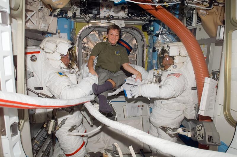 Five years ago today, on Oct. 10, 2007, U.S. astronaut Peggy A. Whitson, the first woman to command the International Space Station, launched with Expedition 16 crewmates on the Soyuz TMA-11.

Pictured here on Oct. 28, 2007, Whitson, takes a moment to pose for a photo with astronauts Scott Parazynski (left), STS-120 mission specialist, and Daniel Tani, Expedition 16 flight engineer, as they prepare for the mission's second session of extravehicular activity (EVA) in the Quest Airlock of the ISS while space shuttle Discovery is docked with the station. Parazynski and Tani are attired in their Extravehicular Mobility Unit (EMU) spacesuits. Courtesy NASA