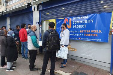 International students line up to receive their food parcels on Monday. Newham Community Project