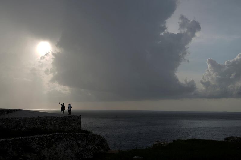 People enjoy the sunset in Havana, Cuba. Reuters