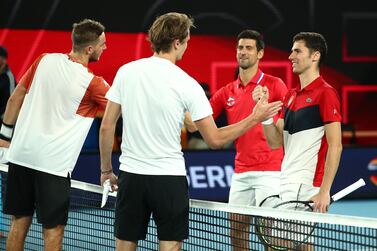 Germany's Alexander Zverev and Jan-Lennard Struff with Serbia's Novak Djokovic and Nikola Cacic after their group stage doubles match. Reuters