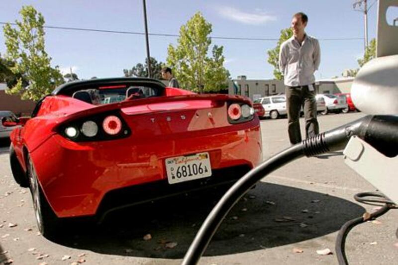 A Tesla Roadster backs into an electric charging station at Tesla Motors Inc in San Carlos, California July 22, 2009. As makers from Tesla to Nissan Motor Co jockey to dominate the next generation electric-powered cars, a fight on which companies will control the lucrative market to fuel them is just getting started. Picture taken July 22. To match feature AUTOS/ELECTRIC REUTERS/Robert Galbraith   (UNITED STATES BUSINESS TRANSPORT POLITICS ENVIRONMENT) *** Local Caption ***  SFO002_AUTOS-ELECTR_0810_11.JPG