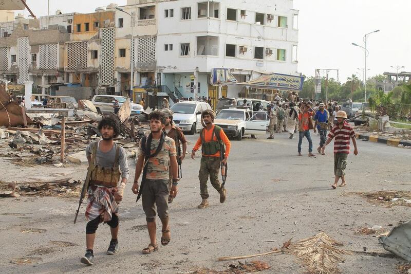 Fighters against Shiite rebels known as Houthis gather at a street in the port city of Aden. Abo Muhammed / AP Photo