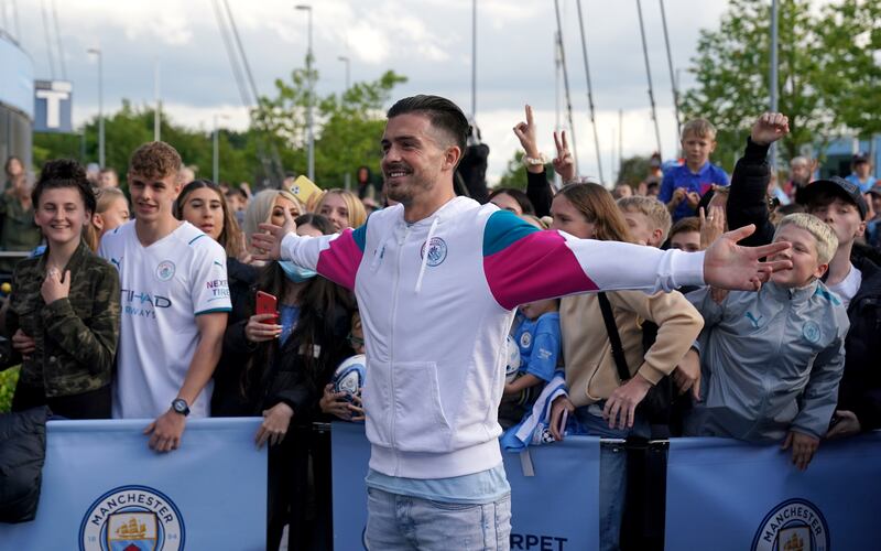 Manchester City's new signing Jack Grealish poses with fans outside the Etihad Stadium on Monday, August 9.