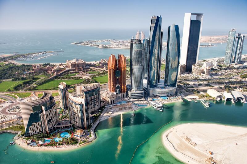 Part of Abu Dhabi, UAE with tall buildings and surrounding area viewed from the helicopter. Many details are visible in the image. Getty Images