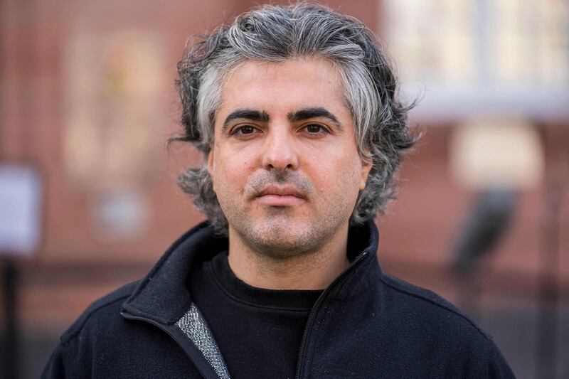 Co-plaintiff filmmaker Feras Fayyad poses in front of the court after the verdict in the trial of a Syrian defendant accused of crimes against humanity in the first trial of its kind to emerge from the Syrian conflict, on February 24, 2021 in Koblenz, western Germany. Eyad al-Gharib, 44, former Syrian intelligence service agent was sentenced to four and a half years in jail for complicity in crimes against humanity in the first court case over state-sponsored torture by the Syrian government. / AFP / Thomas Lohnes
