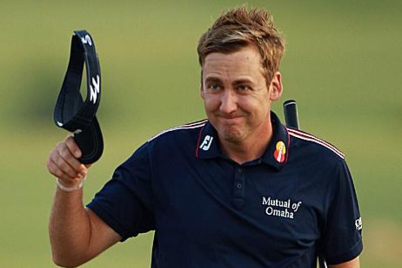 Ian Poulter acknowledges the gallery after finishing the 18th hole at the Earth Course in Dubai.