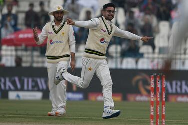 Pakistan's Abrar Ahmed (R) celebrates after the dismissal of England's Zak Crawley (not pictured) during the second day of the second cricket Test match between Pakistan and England at the Multan Cricket Stadium in Multan on December 10, 2022.  (Photo by Aamir QURESHI  /  AFP)