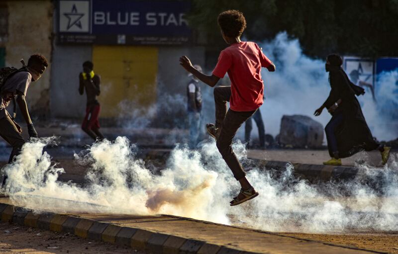 Sudanese youths take to the streets as security forces use tear gas to disperse protesters in the capital Khartoum.  AFP