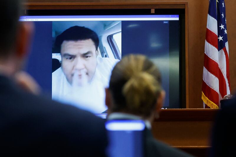 Depp watches the recorded testimony of Alejandro Romero, the doorman at his former penthouse in downtown Los Angeles. AFP