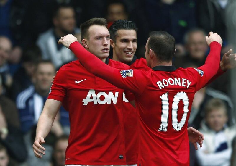 Manchester United's Phil Jones, left, celebrates with teammates after scoring a goal against West Bromwich Albion during their English Premier League match at The Hawthorns on March 8, 2014. Darren Staples / Reuters