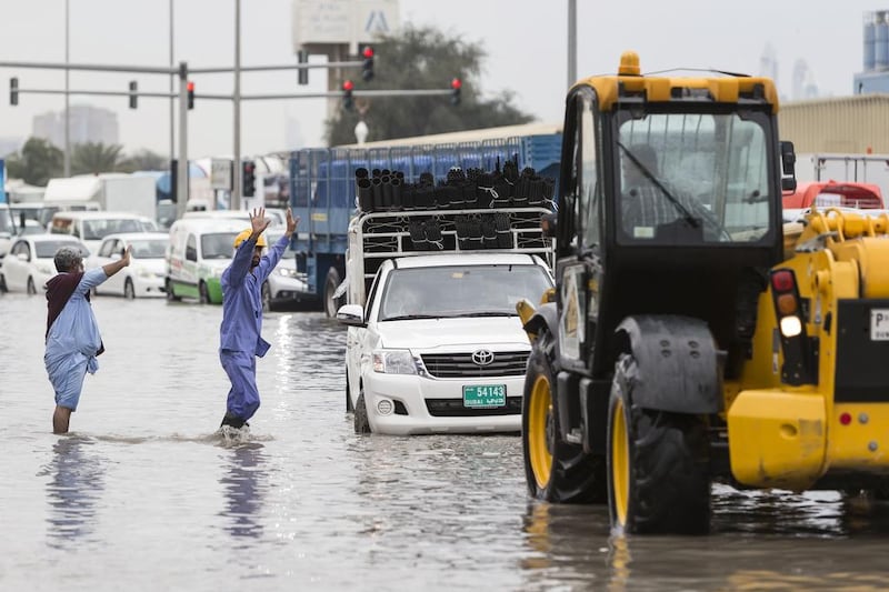 Workers try to organise help on 8th Street in Abu Dhabi. Antonie Robertson/The National