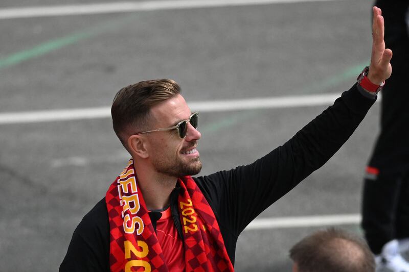 Jordan Henderson waves to supporters during a parade through the streets of Liverpool on Sunday. AFP