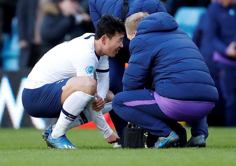Tottenham Hotspur's Son Heung-min holds his arm during the match against Aston Villa. He has now had surgery. Reuters