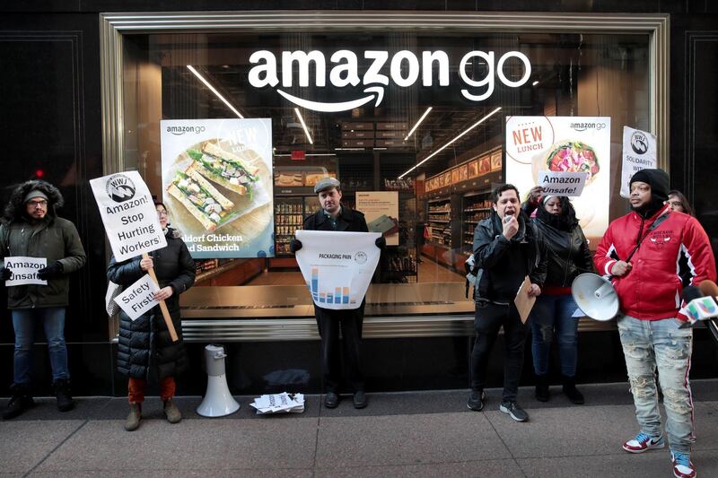 CHICAGO, ILLINOIS - DECEMBER 10: Former injured Amazon employees join labor organizers and community activists to demonstrate and hold a press conference outside of an Amazon Go store in the loop to express concerns about what they claim is the company's "alarming injury rate" among warehouse workers on December 10, 2019 in Chicago, Illinois. According to the community group Warehouse Workers for Justice, some Amazon warehouse facilities have injury rates more than twice the industry average, with peak rates occurring during the holiday season.   Scott Olson/Getty Images/AFP
== FOR NEWSPAPERS, INTERNET, TELCOS & TELEVISION USE ONLY ==
