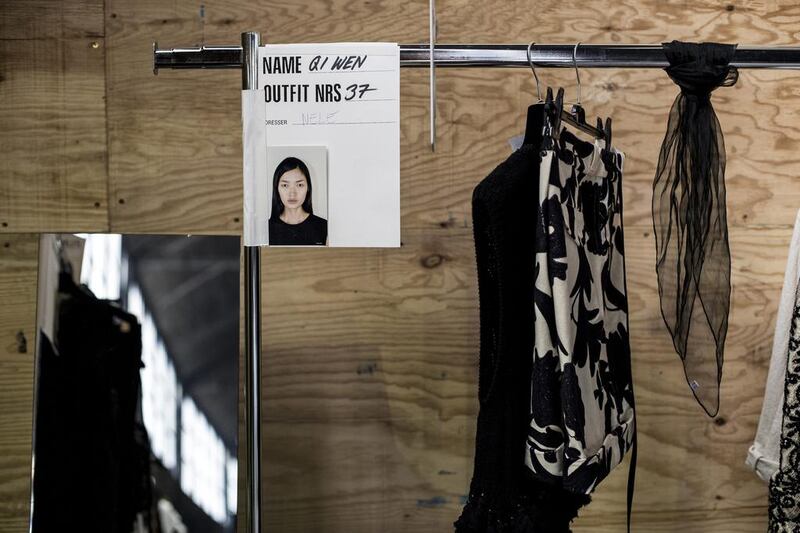 Qiwen Feng's picture adorns her clothes rack prior to the presentation of the Dries Van Noten collection during the Spring/Summer 2014 Ready to Wear Paris Fashion Week, in Paris. Yoan Valat / EPA

