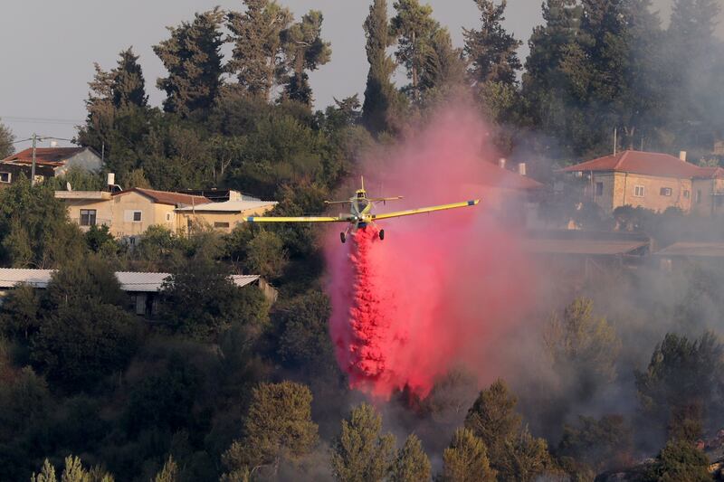 An Israeli firefighting plane drops flame retardant above Kiryat Ye'arim near Jerusalem, Israel.