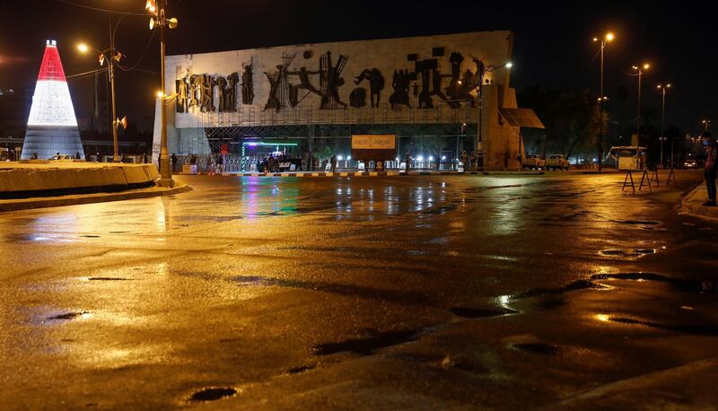 Iraqi police officers stand guard on a street after the start of a Covid-19 curfew in Baghdad. Reuters