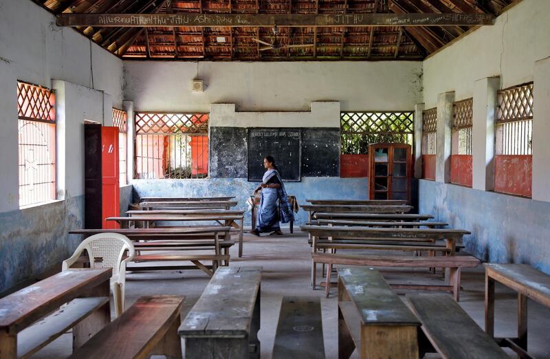 A staff member walks inside an empty classroom of a school after Kerala state government ordered the closure of schools across the state, amid coronavirus fears, in Kochi, India March 12, 2020. REUTERS/Sivaram V