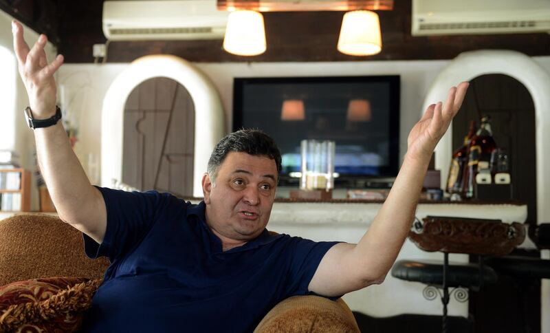 TO GO WITH India-entertainment-Bollywood-dynasties-100years,FOCUS by Rachel O'Brien
In this picture taken on April 29, 2013, India's Bollywood actor Rishi Kapoor gestures as he speaks during an interview with AFP at his house in Mumbai. From a cinema pioneer and India's Charlie Chaplin, one powerful Bollywood family can trace the roots of their stardom almost right back to the birth of the film industry 100 years ago. "We have been there throughout. All the milestones of cinema, there has been some Kapoor or the other," says 60-year-old Rishi Kapoor, who has notched up nearly 150 Hindi film credits over a four-decade acting career.   AFP PHOTO/PUNIT PARANJPE (Photo by PUNIT PARANJPE / AFP)
