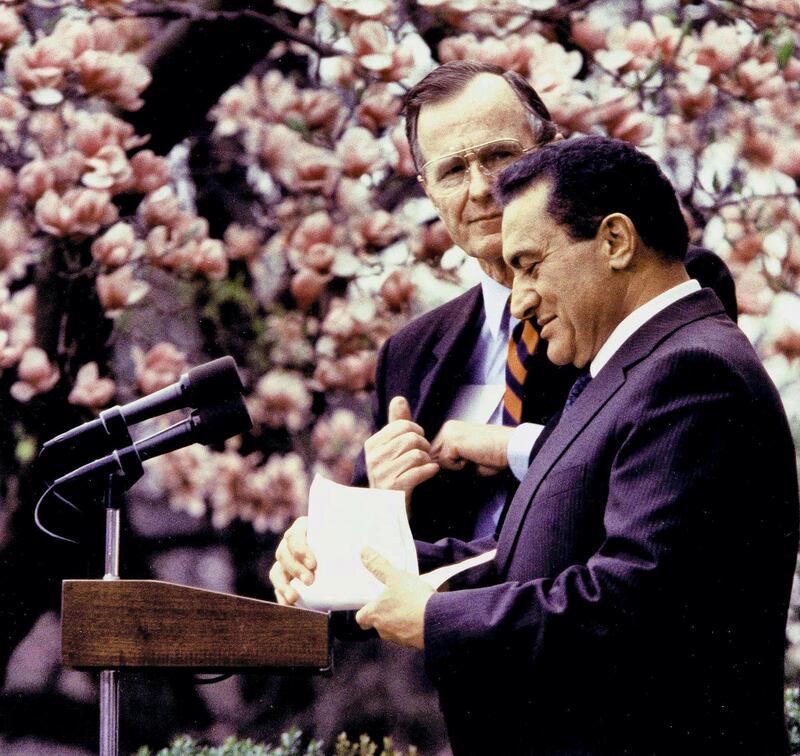 This file photo shows former Egyptian President Hosni Mubarak (R) as he prepares to makes a speech in the Rose Garden 03 April  1989, in Washington,DC, as former US President George Bush looks on. AFP PHOTO/Jerome DELAY (Photo by JEROME DELAY / AFP)