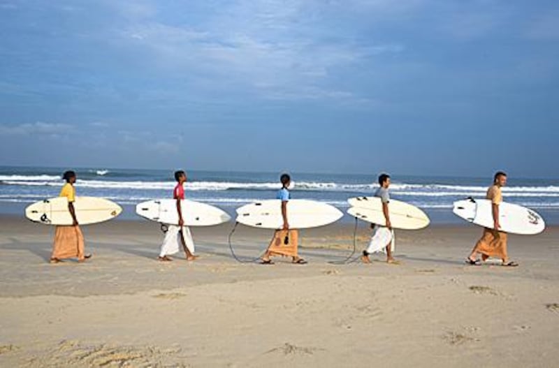 From left: Gaura Gopala, Satyaraj, Kirtan Ananda, Dicky and Daruka Dasa, Krishna devotees at the Kaliya Mardana Krishna Ashram, head out to surf off Mangalore beach in the south Indian state of Karnataka.