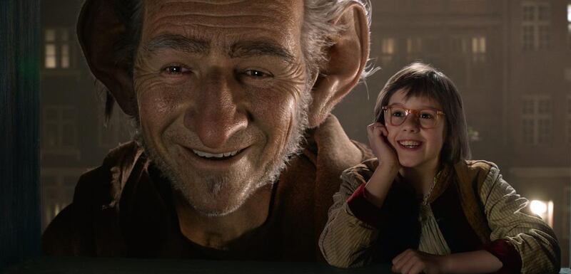 Ruby Barnhill, right, and the Big Friendly Giant  in a scene from The BFG. Disney via AP
