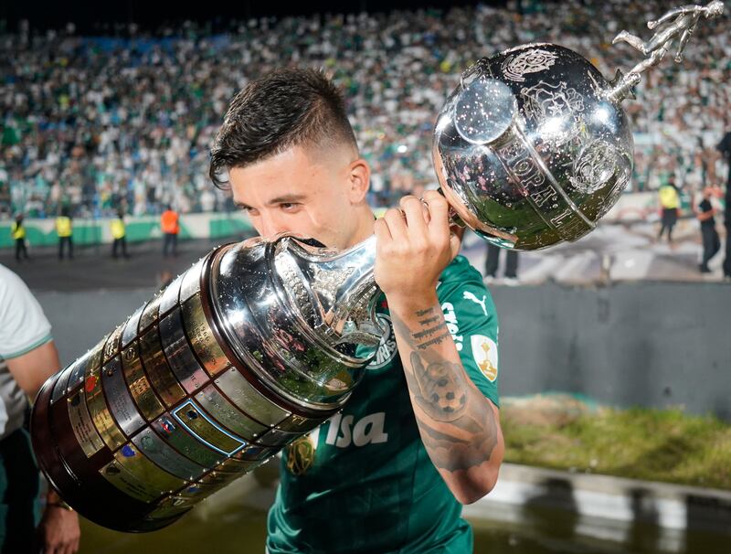 Palmeiras' Victor Luis kisses the Copa Libertadores trophy. Reuters