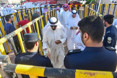 People stand in line to cast their votes for National Assembly elections in Salwa, an area in Hawalli governorate in Kuwait City,  Kuwait, on Thursday. AP