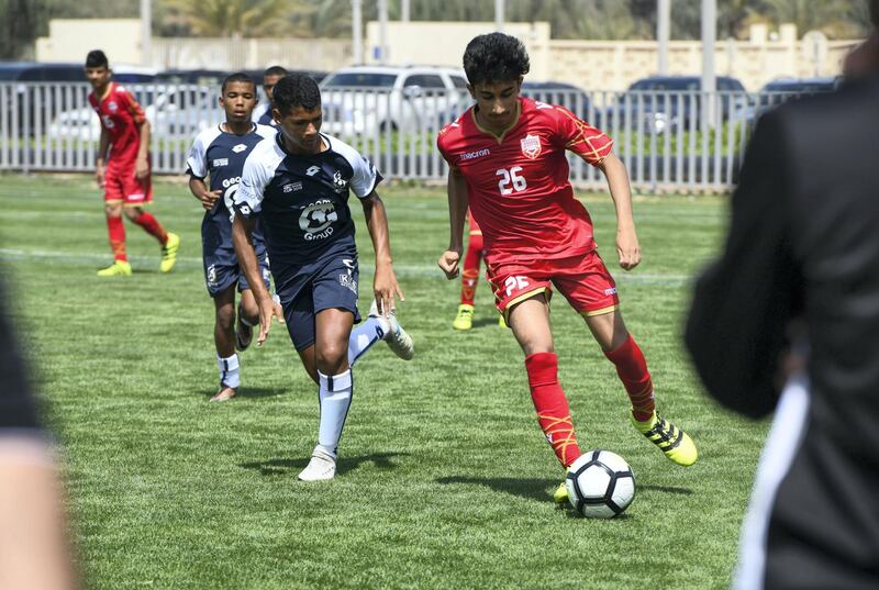 Abu Dhabi, United Arab Emirates - Bahrain National team (red) vs. Legends soccer team from South Africa (white/blue) under 14 age group on Abu Dhabi World Cup Day 1 at Zayed Sports City. Khushnum Bhandari for The National
