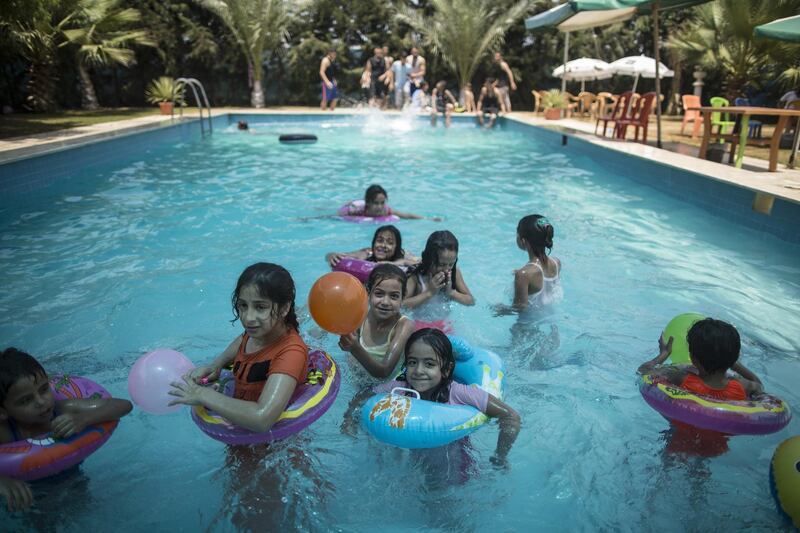 Palestinians spend time at the pool in Gaza City on July 24, 2017.
Around 95 percent of Gaza's groundwater is unsuitable for human consumption. There are few public pools to cool down, while many houses have little water.
 / AFP PHOTO / MAHMUD HAMS