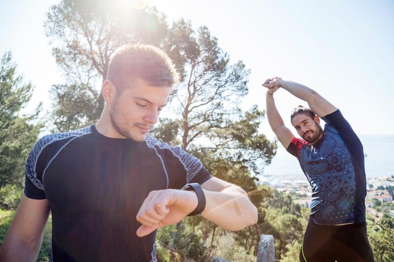 Male runner checking smartwatch in park, Split, Dalmatia, Croatia. Getty Images