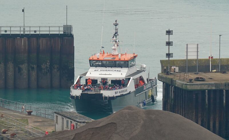 A group of people thought to be migrants are brought to Dover, Kent, on a UK Border Force vessel. PA