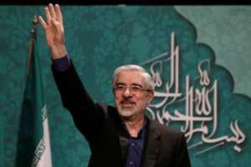 Former Iranian Prime Minister Mirhossein Moussavi waves to journalists after speaking at a news conference in Tehran, April 6, 2009. Iranian President Mahmoud Ahmadinejad's main moderate challenger at the June presidential vote said on Monday he would adopt a conciliatory foreign policy towards the West unlike his "extremist" opponent. Prime minister during Iran's 1980-88 war with Iraq, Mirhossein Mousavi, 67, is seriously considered by many moderates and even some conservatives as their main presidential candidate and a strong rival to Ahmadinejad in the contest.  REUTERS/Morteza Nikoubazl (IRAN POLITICS ELECTIONS HEADSHOT) *** Local Caption ***  TEH103_IRAN-ELECTIO_0406_11.JPG