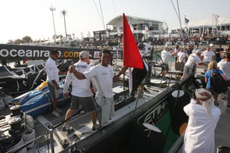 Abu Dhabi, United Arab Emirates, Jan 13 2012, Volvo Import Race- The Volvo Ocean Racing -(centre holding UAE Flag) Adil Khalid and team Abu Dhabi are welcomed by cheering  crowds as the Abu Dhabi team takes the first import race on Friday, Jan 13, 2012. Mike Young / The National