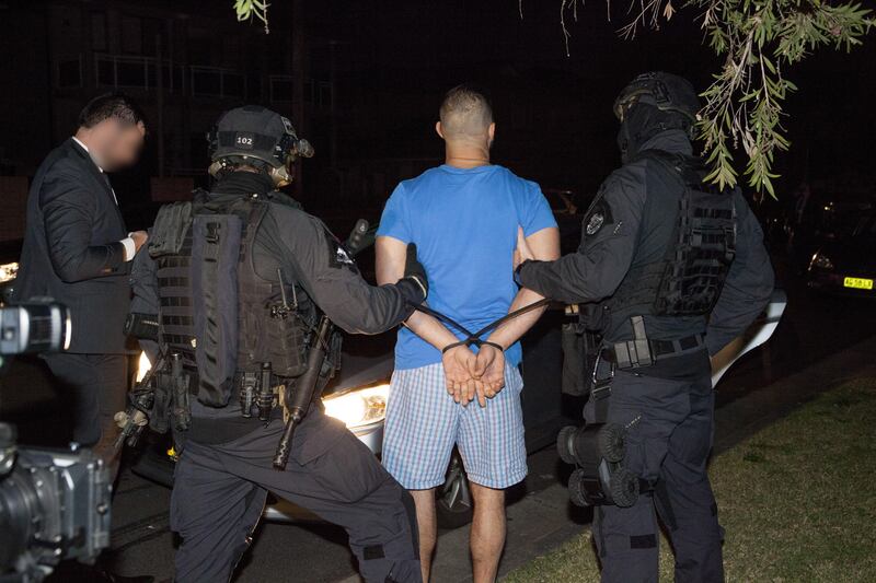 epa06131382 A handout photo made available by the Australian Federal Police (AFP) shows a person being arrested during a series of raids across Sydney, New South Wales, Australia, 08 August 2017. Australian Federal Police have disrupted two inter-related crime syndicates that were allegedly transporting large amounts of ecstasy (MDMA), cocaine and ice between Australia, Dubai and the Netherlands. Seventeen people across three countries were arrested under Operation Vader, AFP Assistant Commissioner Neil Gaughan told reporters on 08 August afternoon.  EPA/AUSTRALIAN FEDERAL POLICE HANDOUT -- ATTENTION EDITORS: IMAGE PIXELATED AT SOURCE -- AUSTRALIA AND NEW ZEALAND OUT HANDOUT EDITORIAL USE ONLY/NO SALES