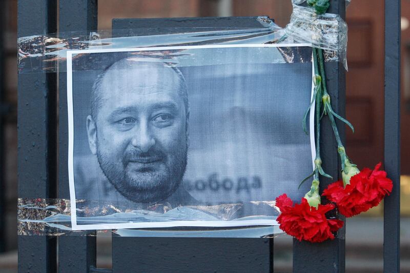 epaselect epa06772534 The Russian opposition journalist Arkady Babchenko portrait is seen on a fence of Russian embassy in Kiev, Ukraine, 30 May 2018. Russian opposition journalist Arkadiy Babchenko, who lived in Ukraine, was shot on 29 May 2018 in his Kiev home by three shots to his back and died from his wounds on the way to hospital, local media report. Babchenko was criticizing Russian authorities and writing about arrests of Crimean-Tatarian journalists in the Crimea after annexation of it by Russia.  EPA/STEPAN FRANKO
