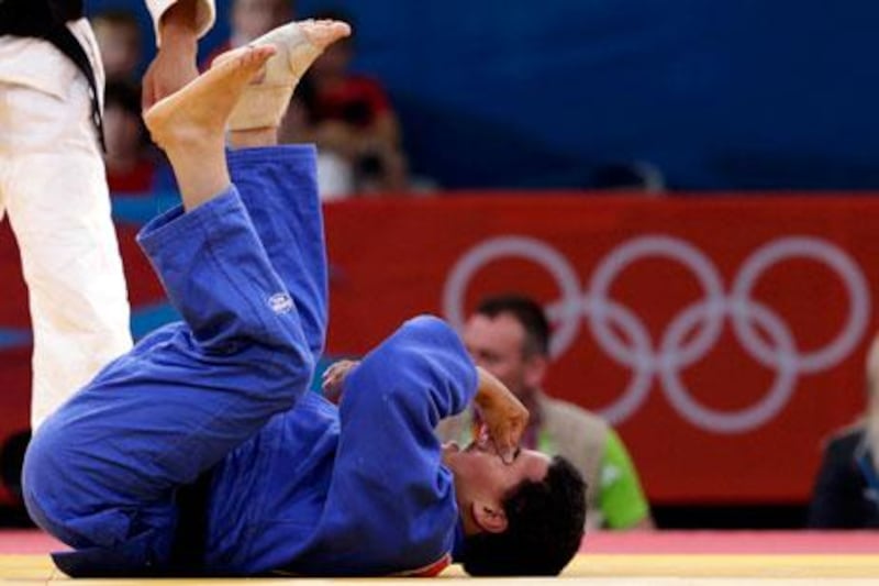 UAE athlete Humaid Al Derei lies on the mat during the elimination round match with Ahmed Award at London 2012.