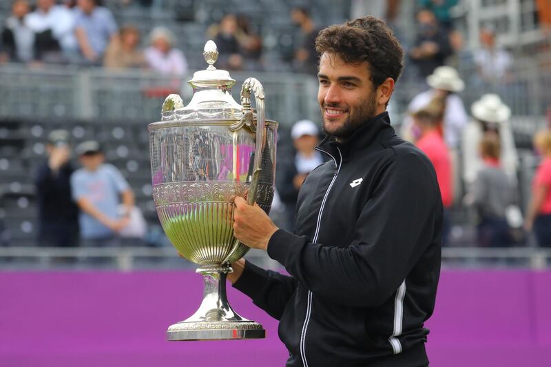 epa09288546 Italy's Matteo Berrettini celebrates with the trophy after winning the final match against  Britain's Cameron Norrie at the Cinch Championships at the Queen's Club in London, Britain, 20 June 2021.  EPA/VICKIE FLORES