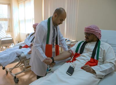 Sharjah, United Arab Emirates - November 30, 2016.  Kifah Abdulwahid ( Medical Technologist, UAE Ministry of Health & Prevention ) assisting Fahad K Khamies ( 33 years old, from the UAE Army ) during the Blood Donation Campaign, held at the Blood Transfusion & Research Center.  ( Jeffrey E Biteng / The National )  Editor's Note;  ID 14957 *** Local Caption ***  JB301116-BDonation04.jpg