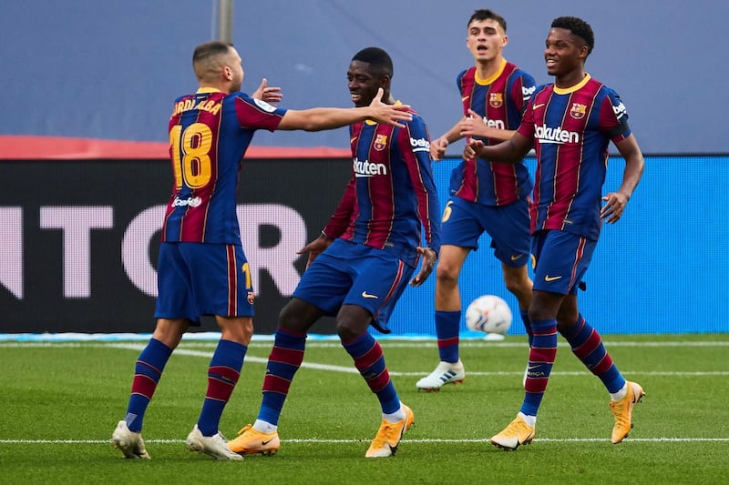 Barcelona's striker Ousmane Dembele celebrates with teammates after scoring against Real Betis. EPA