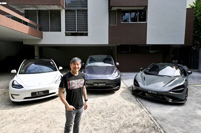 Eu Gene Goh with his three cars, a Tesla Model 3, a Tesla Model Y and a McLaren 765LT in Singapore. Reuters 
