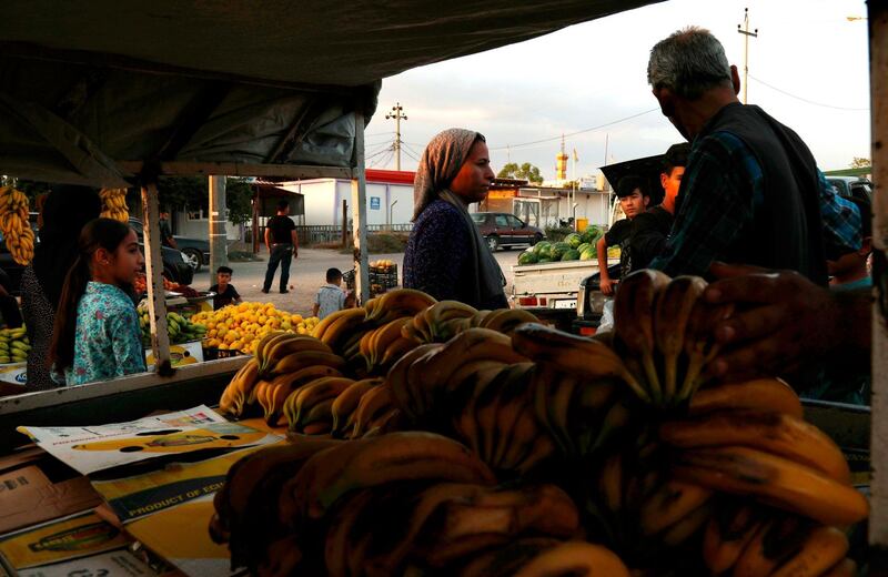Street vendors display produce at the Domiz refugee camp, which houses Syrian-Kurdish refugees, 20 km southeast of the northern Iraqi city of Dohuk.   AFP