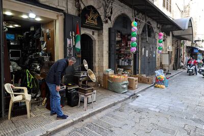 Hemmou displays old record players in front of his shop. AFP