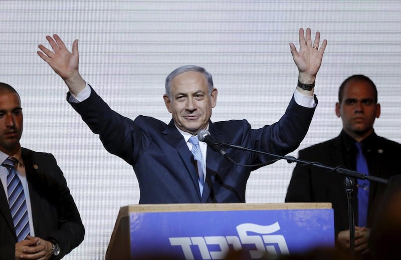 Israel's Benjamin Netanyahu (C) waves to supporters in Tel Aviv (REUTERS/Amir Cohen)