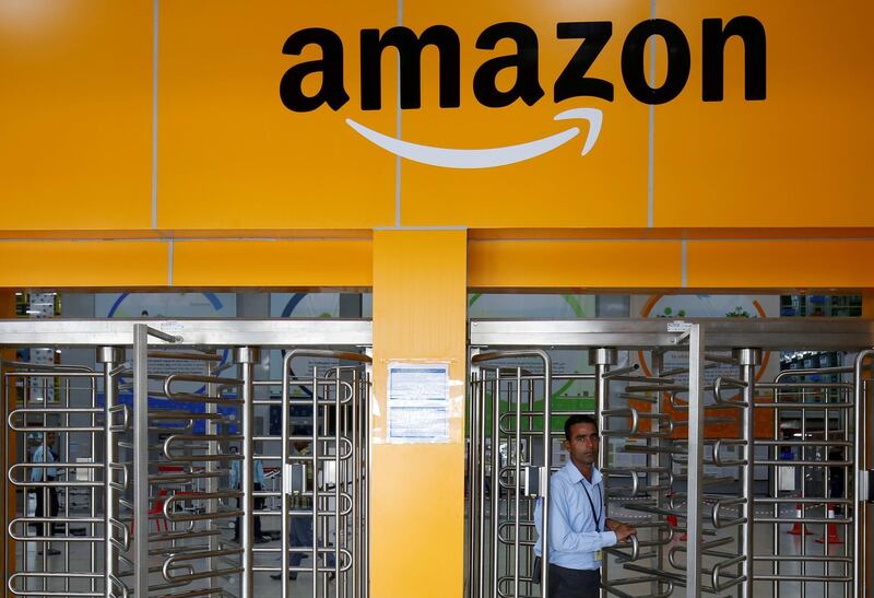 FILE PHOTO: An employee of Amazon walks through a turnstile gate inside an Amazon Fulfillment Centre (BLR7) on the outskirts of Bengaluru, India, September 18, 2018. REUTERS/ Abhishek N. Chinnappa/File Photo