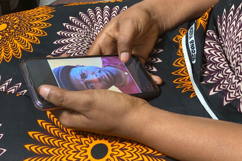 Anifa holds her phone displaying a photo of former World Health Organisation doctor Boubacar Diallo, during an interview in the eastern Congo town of Goma. Photo: AP