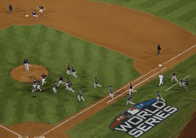 Boston Red Sox run onto the field to celebrate. AP Photo