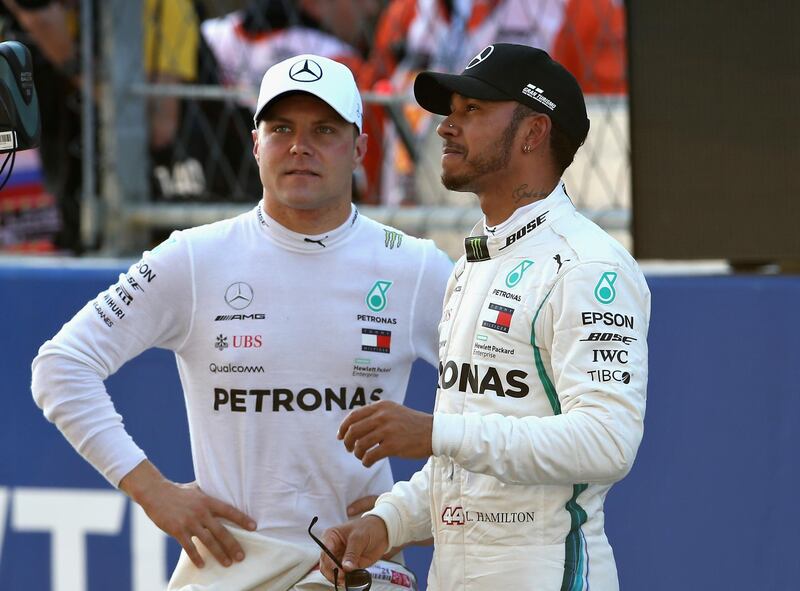 SOCHI, RUSSIA - SEPTEMBER 29:  Pole position qualifier Valtteri Bottas of Finland and Mercedes GP talks with second place qualifier Lewis Hamilton of Great Britain and Mercedes GP in parc ferme during qualifying for the Formula One Grand Prix of Russia at Sochi Autodrom on September 29, 2018 in Sochi, Russia.  (Photo by Charles Coates/Getty Images)